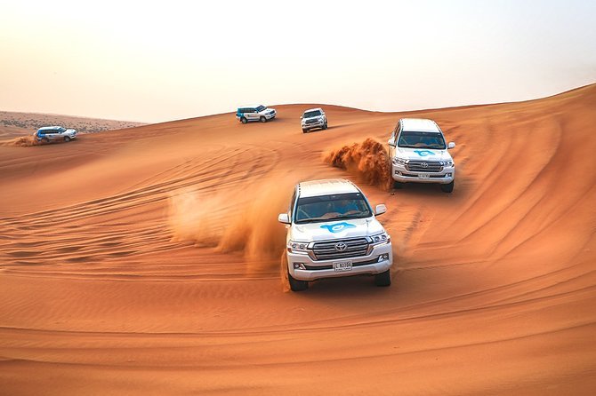 4x4 SUVs dune bashing on the Al Awir red dunes