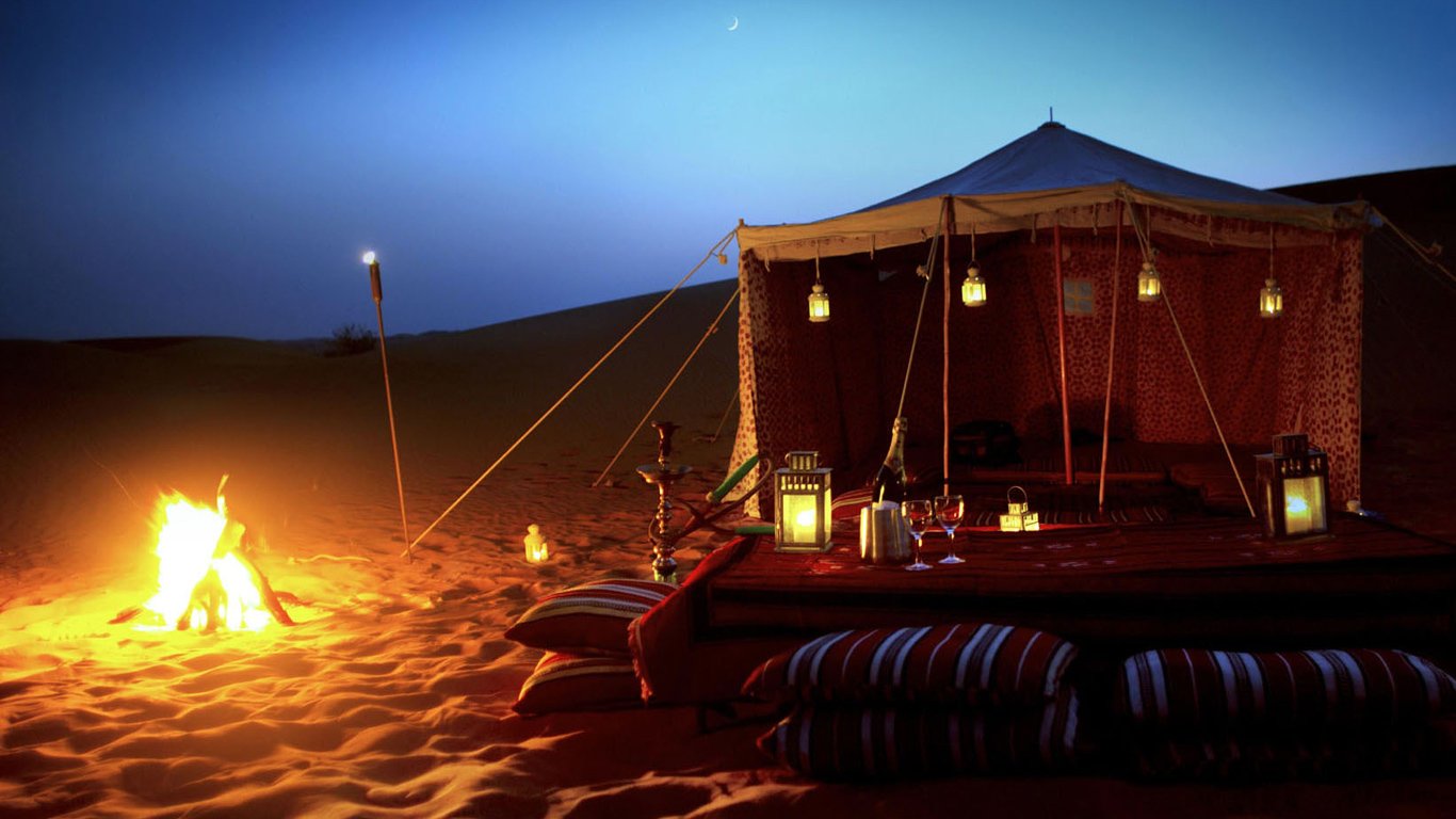 Camel train at golden hour in peak Dubai desert safari season