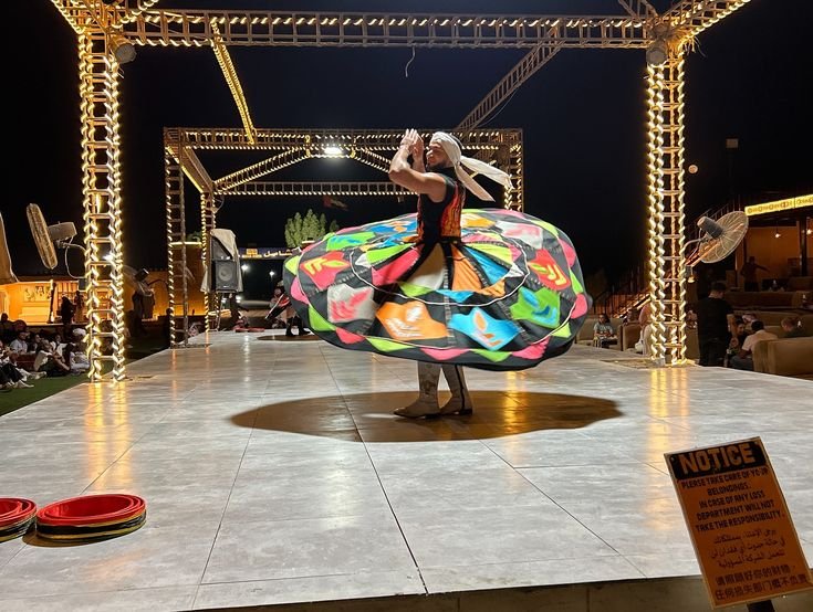 Colorful Tanoura dance performance at the desert safari camp