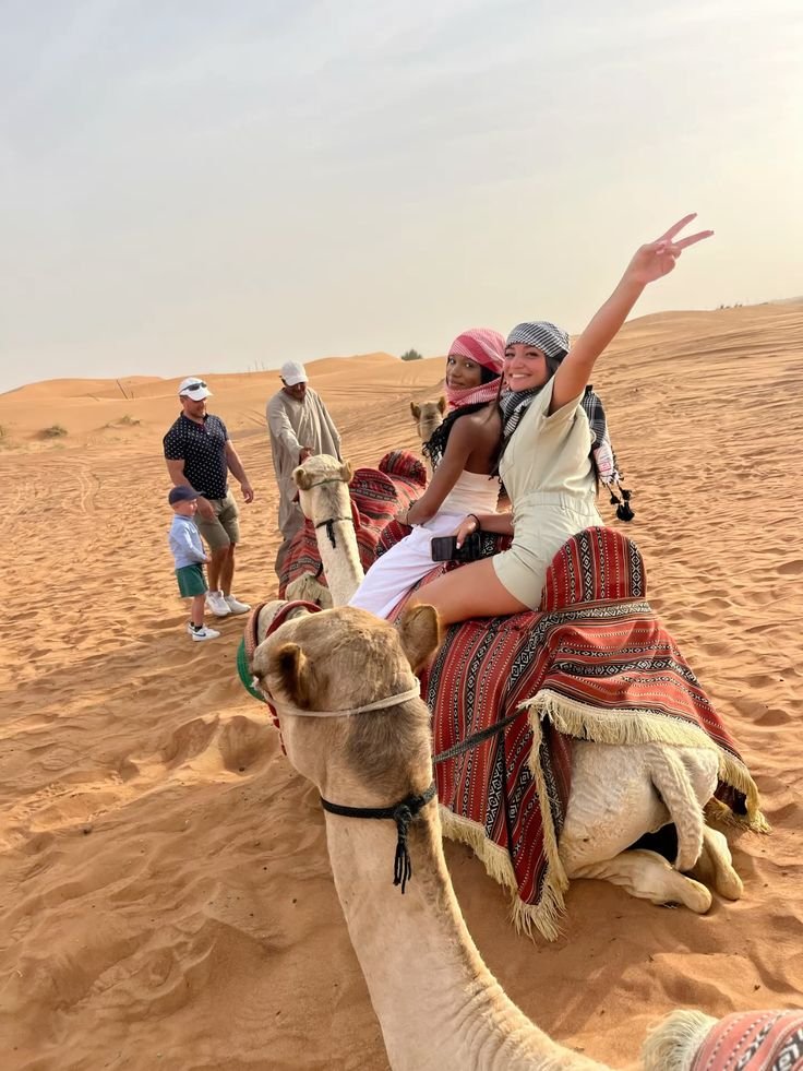 Friends posing on a camel during the camel ride