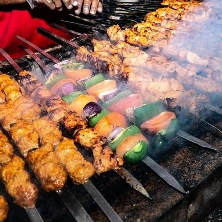 Grilled kebabs and vegetable skewers on the desert safari BBQ