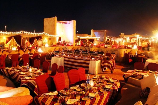Illuminated desert safari camp dining tables at night