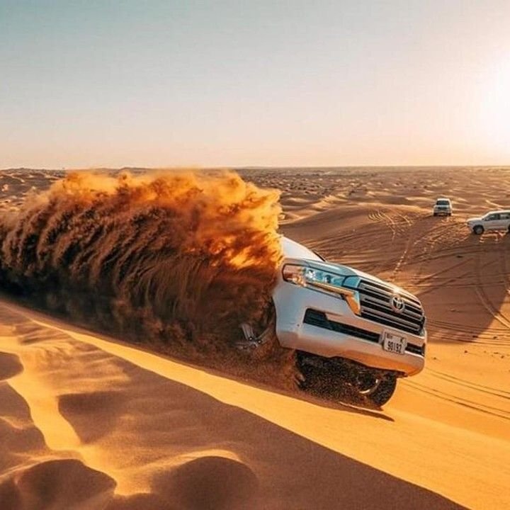 Land Cruiser dune bashing at golden hour in the desert